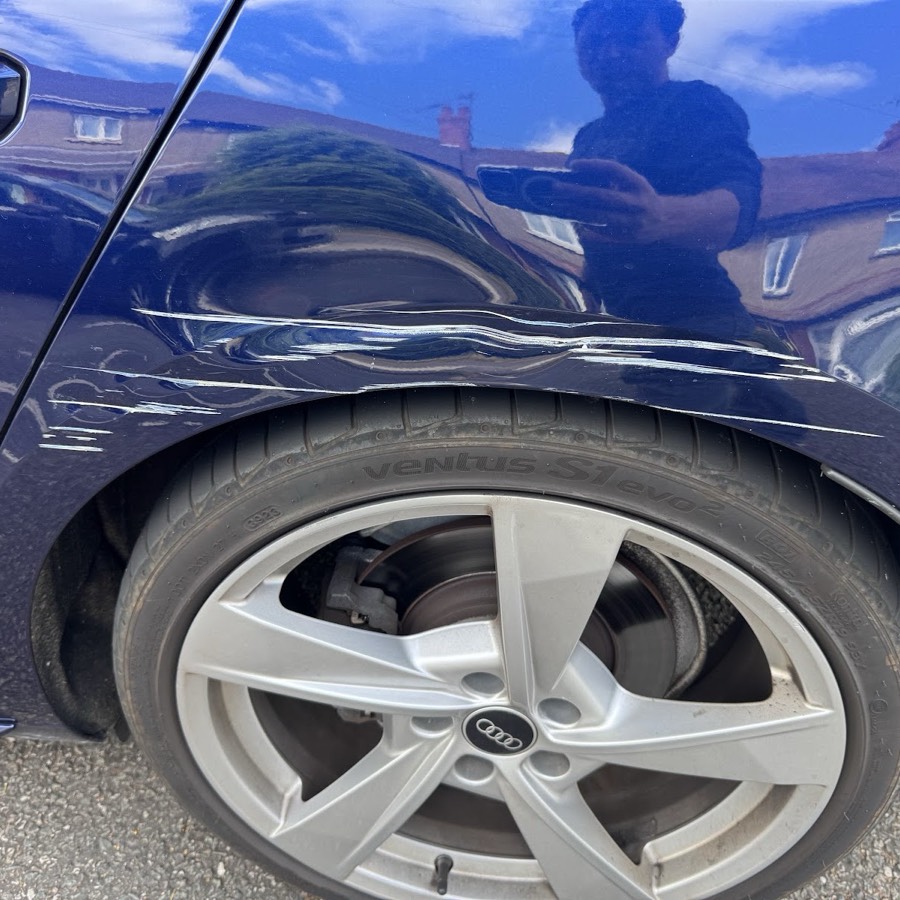 Audi rear wheel arch dent and scuff before repair at Nima Auto Body Repair